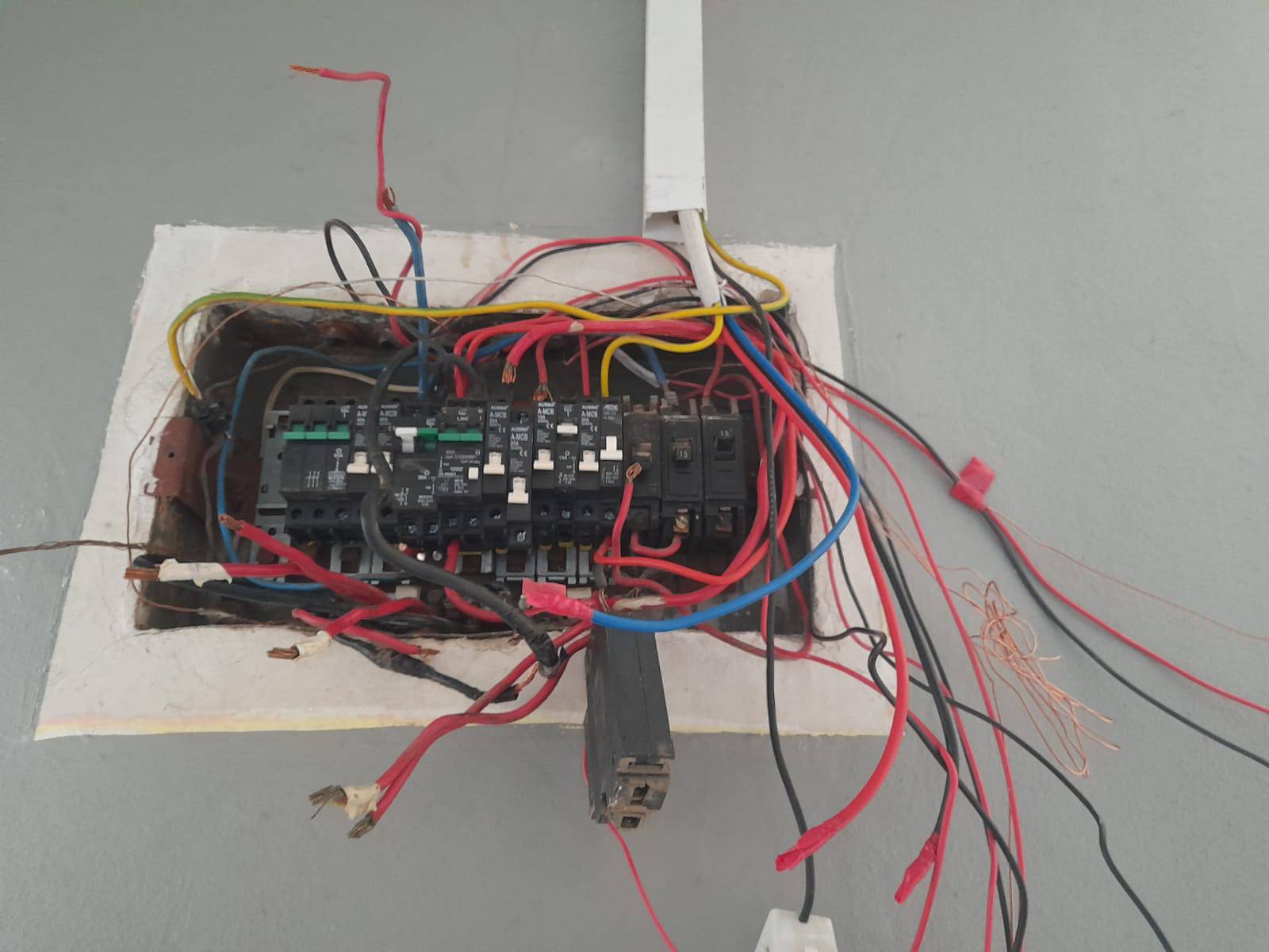Non-compliant distribution board before Electrical COC repairs